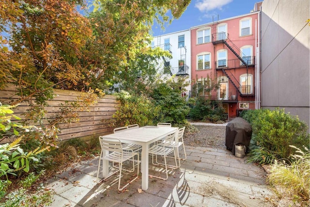 view of patio / terrace featuring outdoor dining area, fence, and grilling area