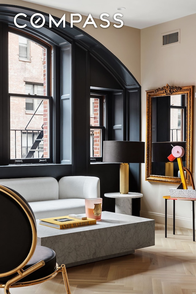 sitting room featuring a wealth of natural light, visible vents, and baseboards