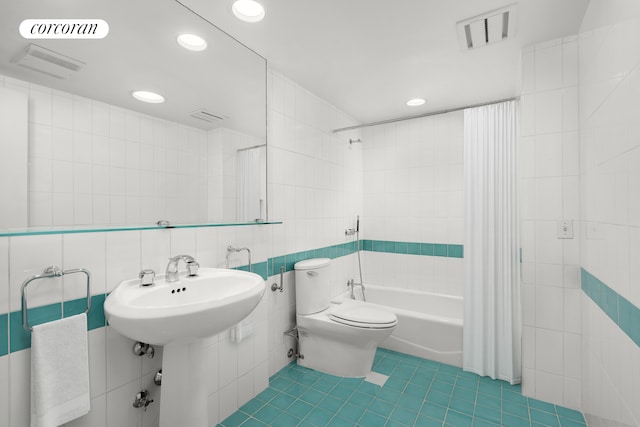 27 E 65th St Unit 5Bc, New York City, NY 10065 - bathroom with tile walls, shower / bathtub combination with curtain, tile patterned floors, and recessed lighting