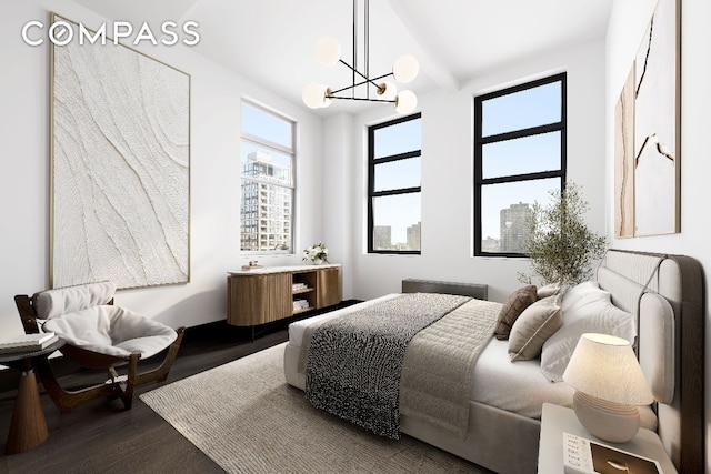 bedroom with hardwood / wood-style floors, a notable chandelier, and beamed ceiling