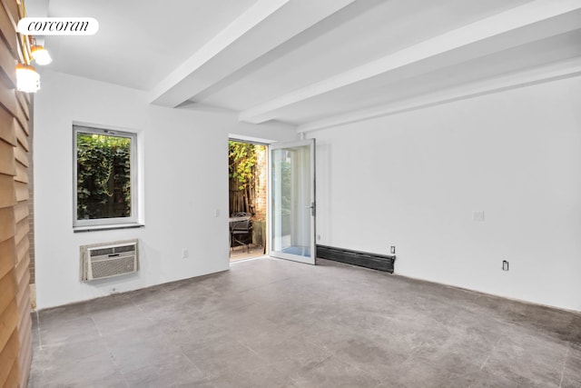 empty room featuring an AC wall unit and beamed ceiling