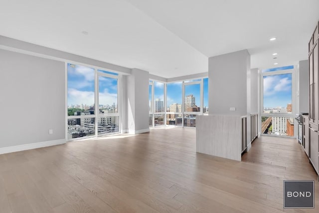 unfurnished living room with light hardwood / wood-style flooring and expansive windows