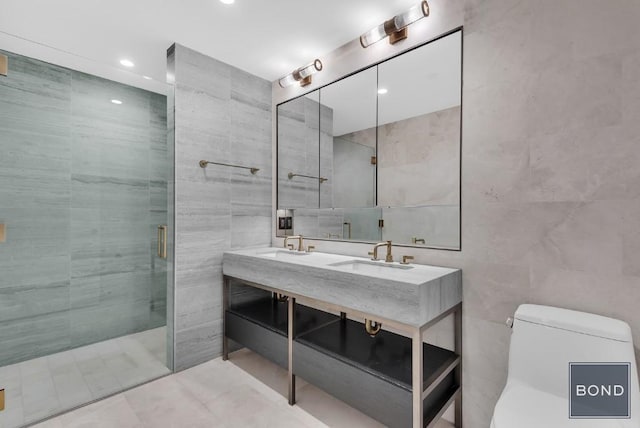 bathroom with a shower with shower door, vanity, tile walls, and toilet