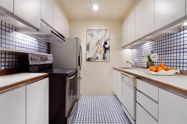 kitchen featuring sink, stainless steel range with electric cooktop, white dishwasher, and white cabinetry