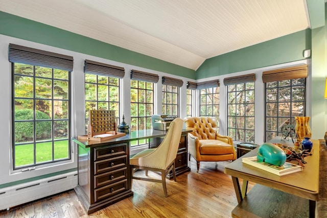 sunroom with a baseboard heating unit and lofted ceiling