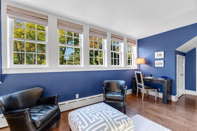 sitting room with a baseboard radiator and hardwood / wood-style floors