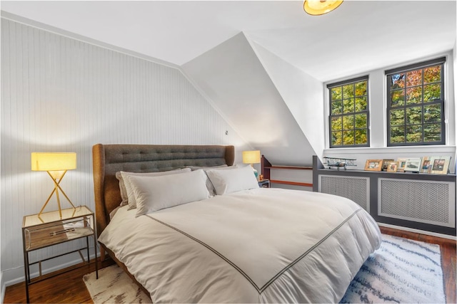 bedroom featuring lofted ceiling and dark hardwood / wood-style flooring