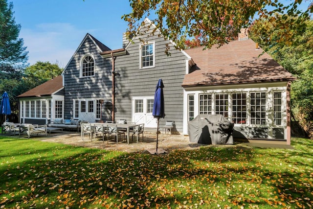 back of property with a patio, a yard, and an outdoor hangout area