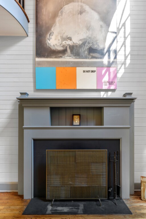 interior details featuring a fireplace, hardwood / wood-style flooring, and wood walls