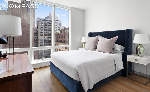325 Lexington Ave Unit 10D, New York City, NY 10016 - bedroom featuring a view of city and wood finished floors