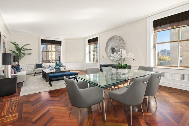 dining room featuring crown molding and dark parquet floors