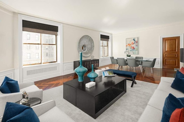 living room with crown molding, parquet flooring, and a wealth of natural light