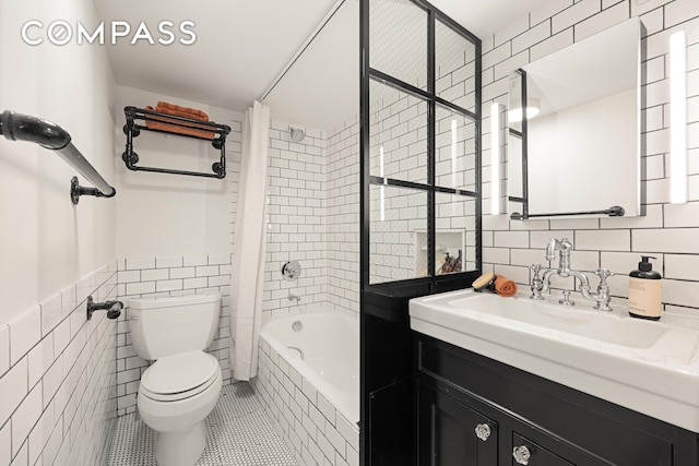 300 E 4th St Unit 2A, New York City, NY 10009 - full bathroom featuring tile walls, toilet, tile patterned flooring, vanity, and tiled shower / bath