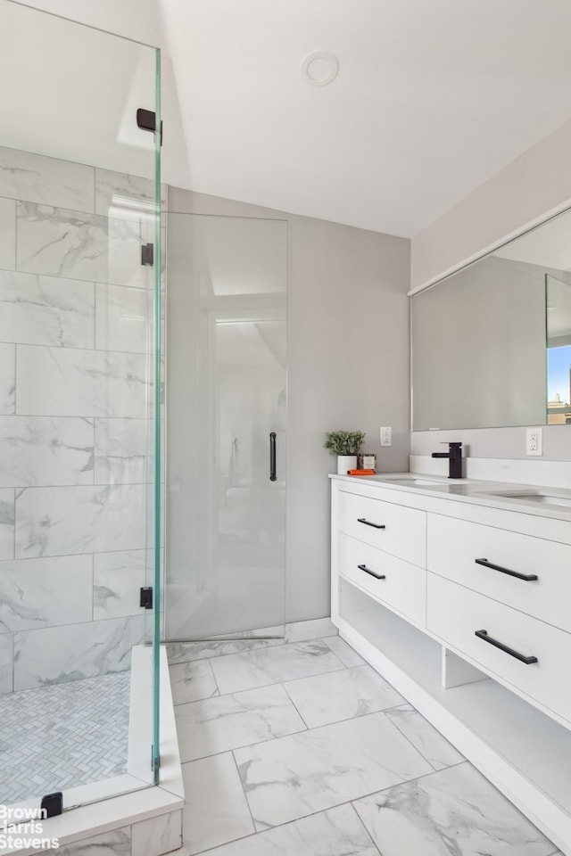 full bathroom with marble finish floor, a stall shower, and vanity