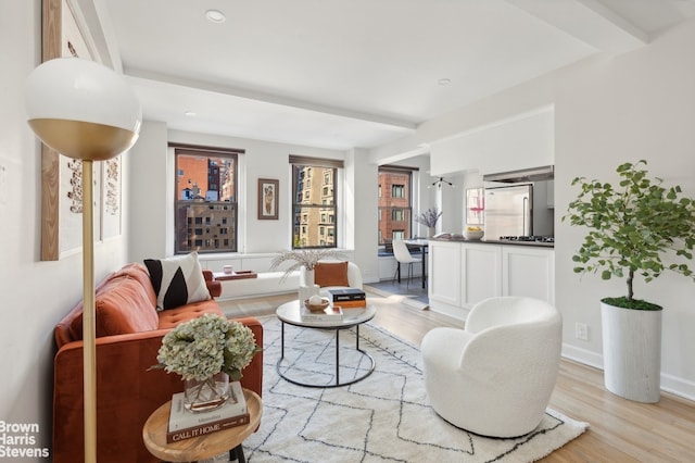 living room featuring light wood-type flooring and baseboards