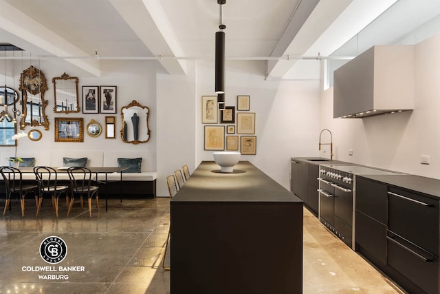 kitchen with range with two ovens, modern cabinets, a sink, dark countertops, and dark cabinetry