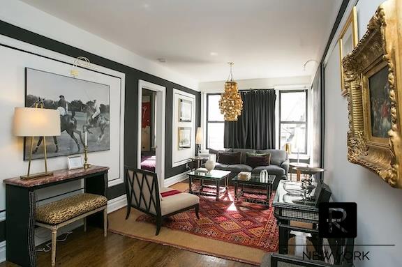 living area with baseboards and wood finished floors