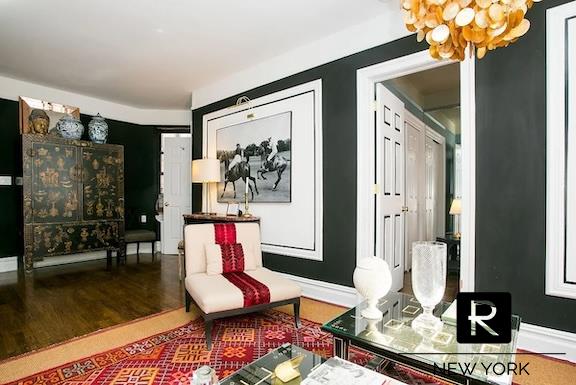 living area with baseboards and wood finished floors