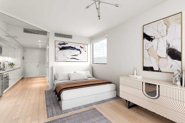 bedroom with light wood-type flooring