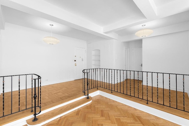 corridor featuring parquet floors and beam ceiling