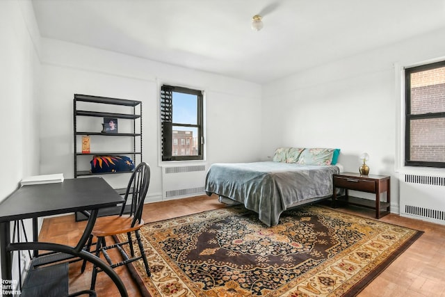 bedroom with radiator and parquet floors