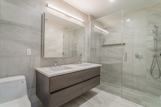249 E 50th St Unit 7A, New York City, NY 10022 - full bathroom with tile walls, toilet, a stall shower, and double vanity