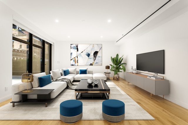 249 E 50th St Unit 7A, New York City, NY 10022 - living room with light wood-type flooring, recessed lighting, and baseboards