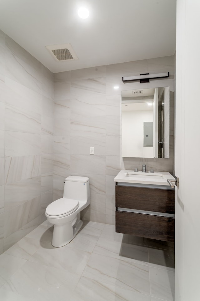 249 E 50th St Unit 7A, New York City, NY 10022 - bathroom featuring tile walls, toilet, and vanity