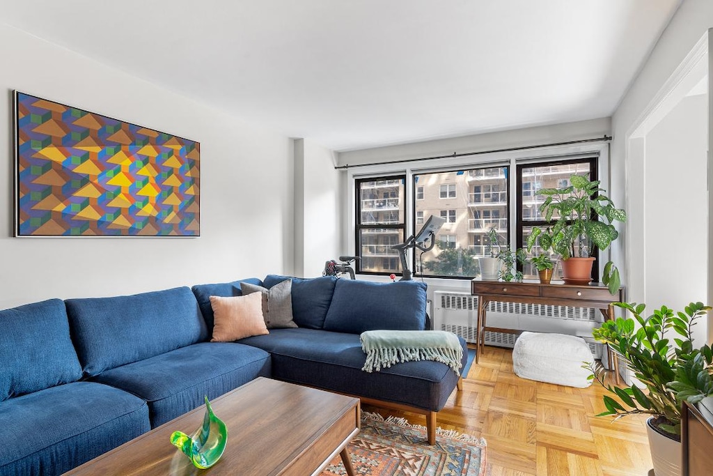 living room featuring radiator and parquet floors