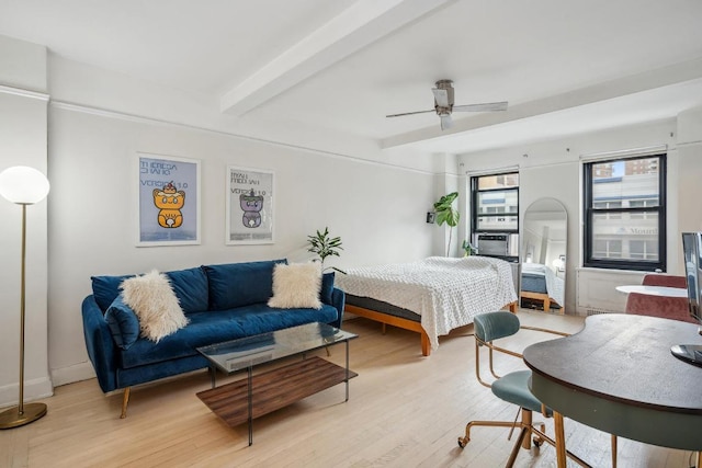 bedroom featuring beamed ceiling, ceiling fan, and light hardwood / wood-style flooring