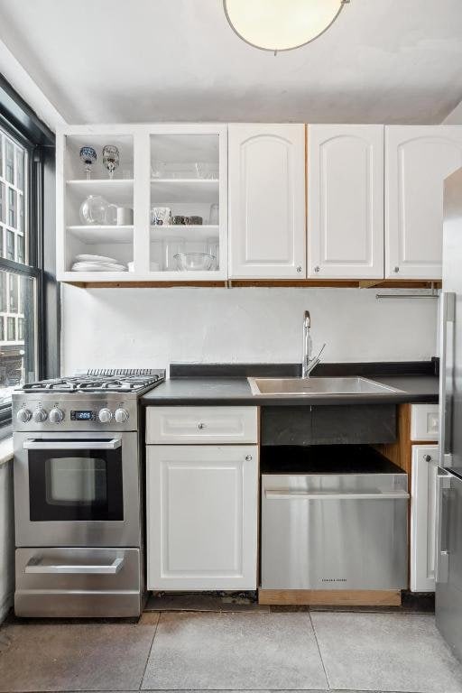 kitchen featuring appliances with stainless steel finishes, sink, and white cabinets