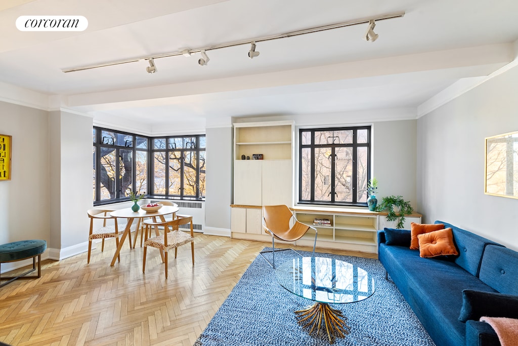 living room with radiator, visible vents, and baseboards