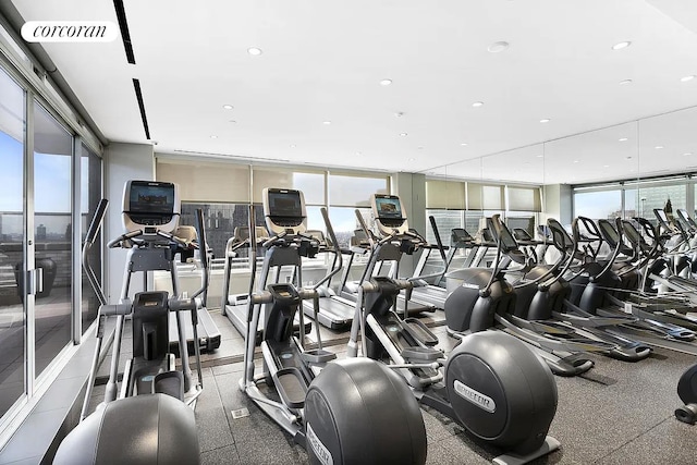 workout area with a wall of windows, visible vents, and a wealth of natural light