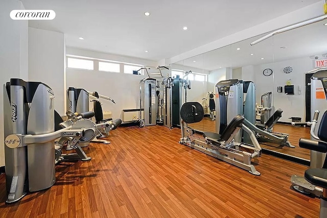 workout area with recessed lighting, visible vents, and wood finished floors