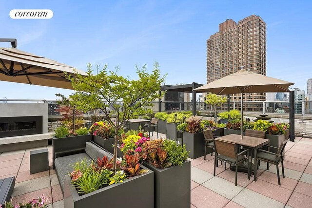 view of patio featuring outdoor dining space and a view of city