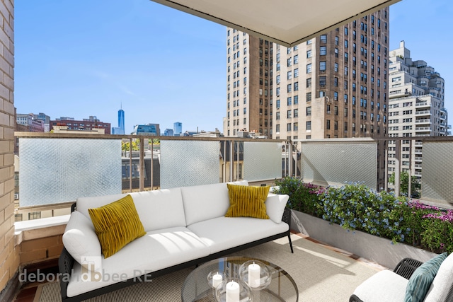 balcony with a city view and outdoor lounge area