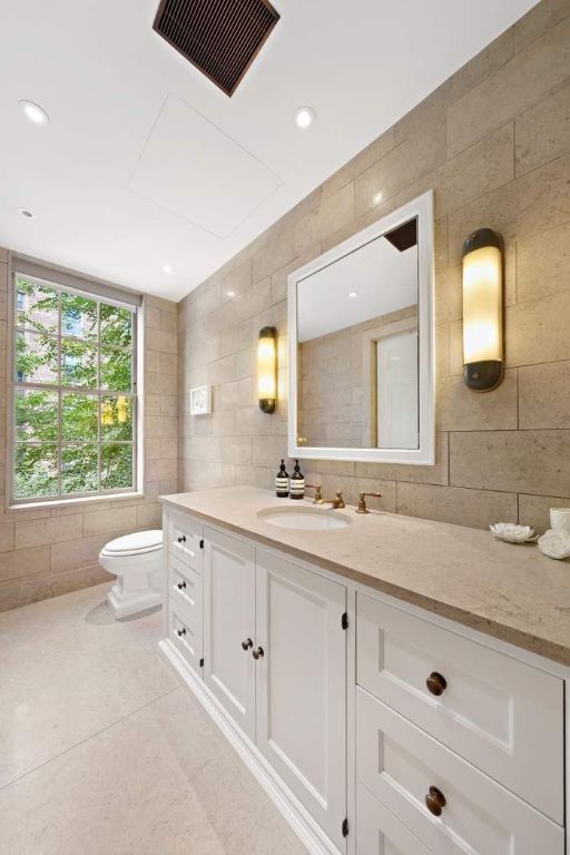 bathroom featuring tile walls, vanity, tile patterned floors, and toilet