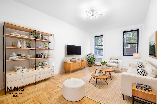 living room featuring light parquet floors and an inviting chandelier