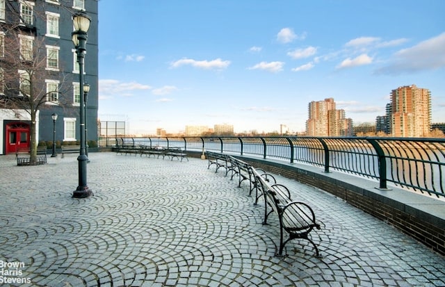 view of community featuring fence and a city view