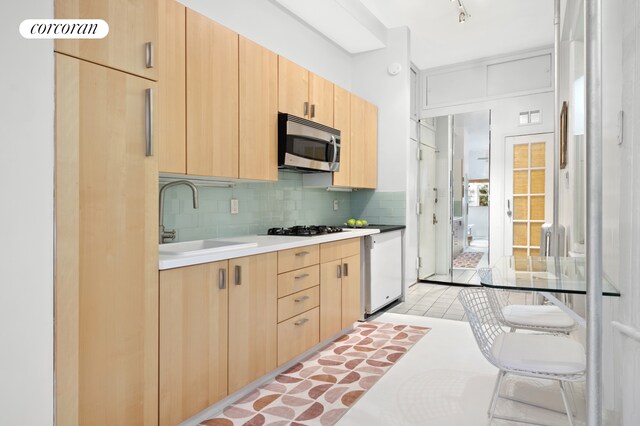 bathroom featuring decorative backsplash, toilet, shower / bathtub combination with curtain, and tile patterned flooring