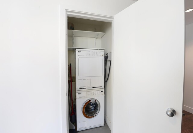 clothes washing area featuring laundry area and stacked washer / drying machine