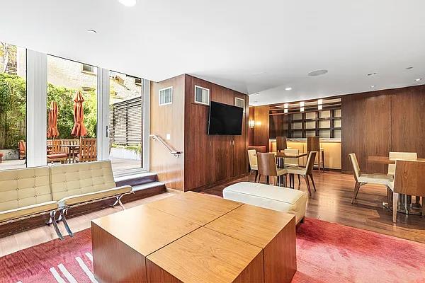 living room with wood walls and wood finished floors