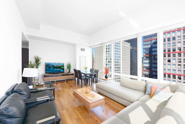 250 E 53rd St Unit 3302, New York City, NY 10022 - living room featuring wood finished floors