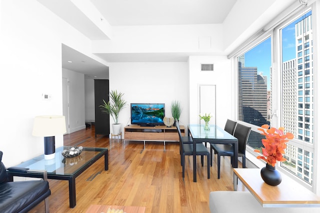 living area featuring light wood finished floors and baseboards