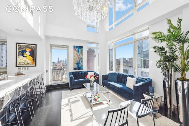 living room with a view of city, dark wood-style flooring, and a wealth of natural light