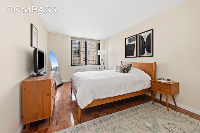 bedroom with dark parquet floors