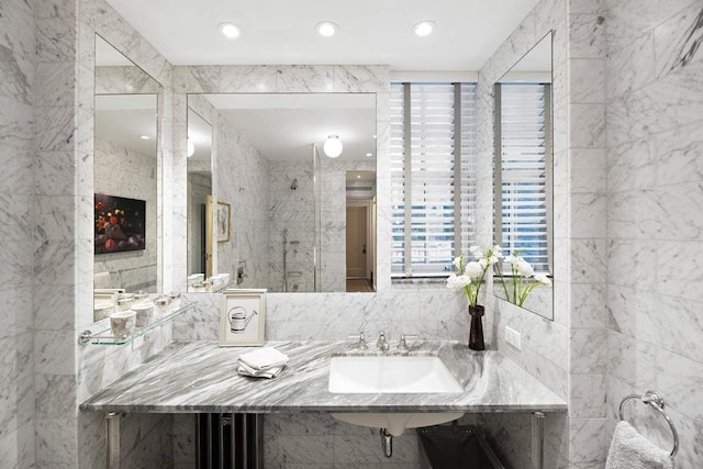 45 E 9th St Unit 45, New York City, NY 10003 - bathroom with tile walls, recessed lighting, and a sink
