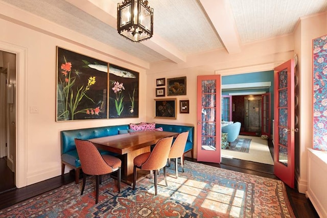 45 E 9th St Unit 45, New York City, NY 10003 - dining space with a chandelier, breakfast area, baseboards, beam ceiling, and wood finished floors