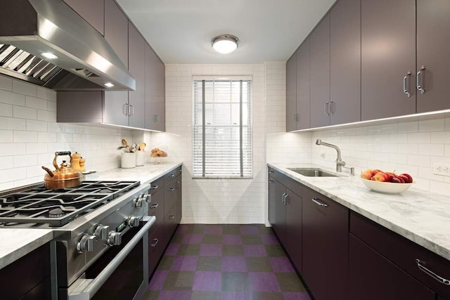 45 E 9th St Unit 45, New York City, NY 10003 - kitchen with decorative backsplash, a sink, dark floors, exhaust hood, and stainless steel stove