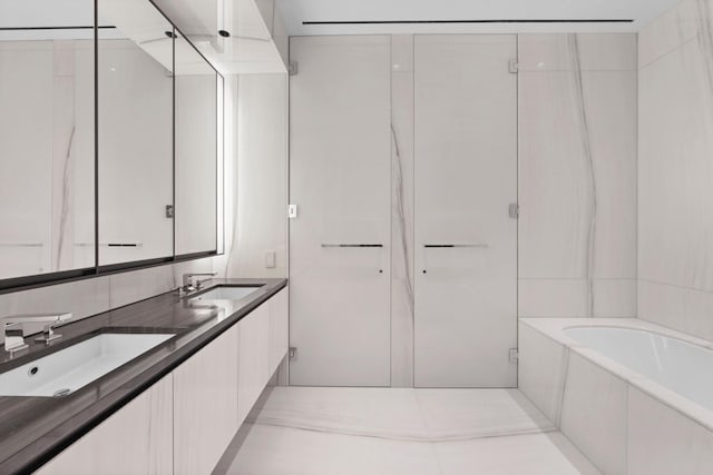 bathroom featuring a garden tub, an enclosed shower, double vanity, and a sink